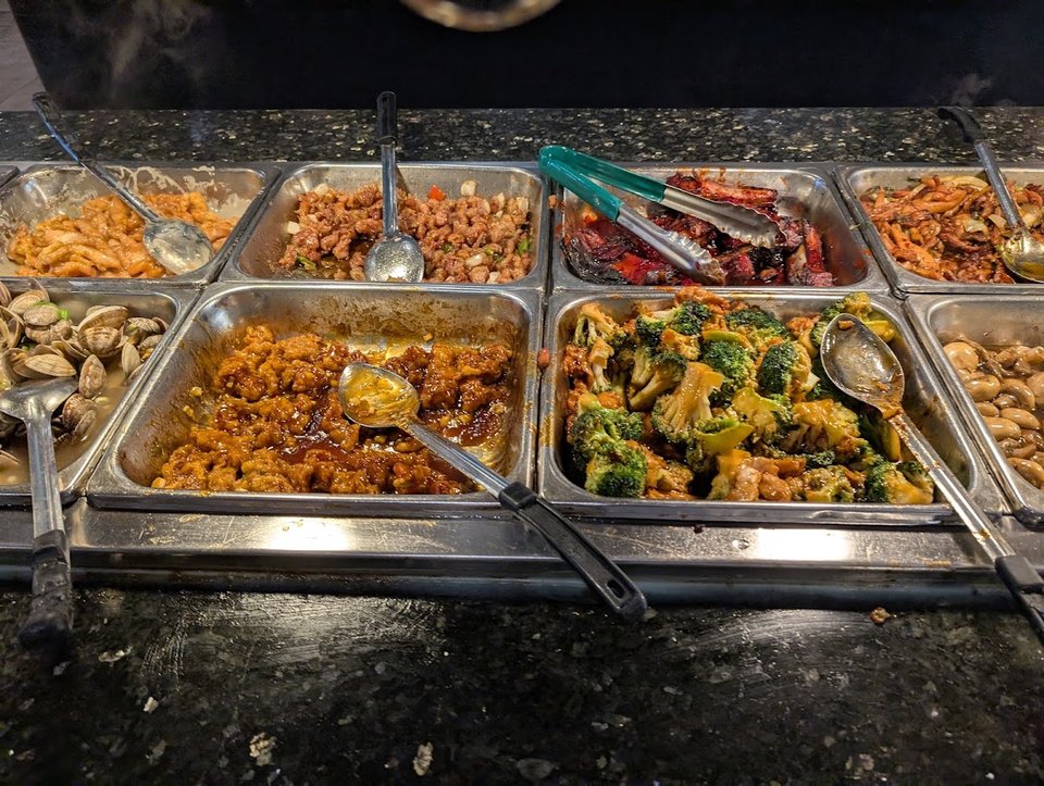Seafood station beside lo mein and dumplings.